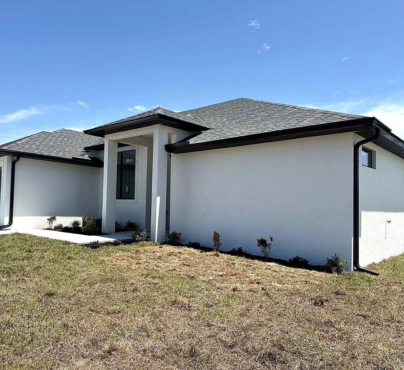 Gutter and downspout install, angled roofline view