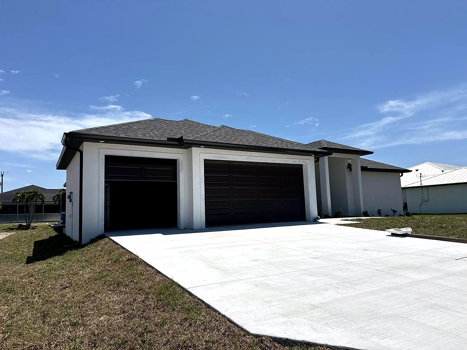 Gutter installation along three-car garage roofline